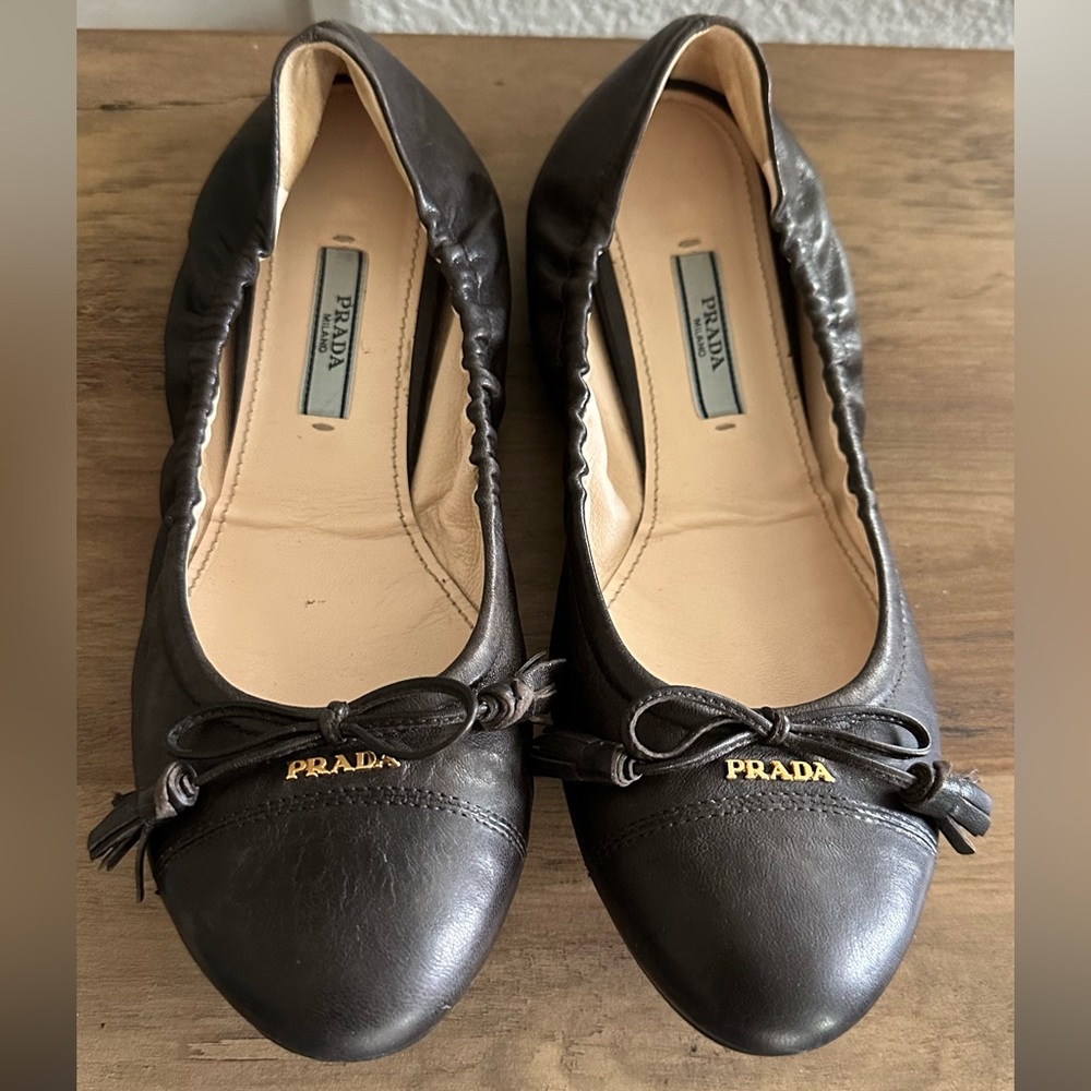 Prada Women's Chocolate Leather Ballet Flats with a classic bow and gold logo
